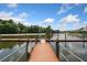 Beautiful lake view featuring a wooden dock, perfect for boating or relaxing by the water at 11008 Tahiti Isle Ln, Tampa, FL 33647