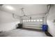 Well-lit two car garage featuring concrete floors and garage door opener at 11008 Tahiti Isle Ln, Tampa, FL 33647