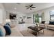 Open-concept living area with kitchen view, modern furnishings, neutral tones, and ample natural light at 11008 Tahiti Isle Ln, Tampa, FL 33647
