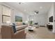 Bright living room with neutral furniture, large windows, and tiled floors for a modern, airy feel at 11008 Tahiti Isle Ln, Tampa, FL 33647