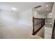 Upstairs loft area with carpeting, natural light, and a decorative staircase railing at 11008 Tahiti Isle Ln, Tampa, FL 33647