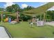 Bright and colorful community playground with climbing structures and shaded areas for  at 11008 Tahiti Isle Ln, Tampa, FL 33647