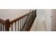 Elegant wooden staircase featuring decorative iron railings and plush carpeting at 11008 Tahiti Isle Ln, Tampa, FL 33647