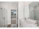 Bathroom featuring dual sinks, walk-in shower and bedroom access at 12150 Cattleside Dr, Riverview, FL 33579
