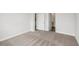 Bedroom view showcases neutral carpet and bathroom and closet access at 12150 Cattleside Dr, Riverview, FL 33579
