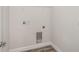Utility room with wood-look flooring and wire shelving for laundry storage at 12150 Cattleside Dr, Riverview, FL 33579