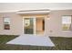 Back patio with sliding glass door and grass with a view of the yard at 13008 Wellspring Dr, Lithia, FL 33547