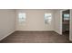 Bedroom with neutral walls, carpet, and two windows with views of neighborhood at 13008 Wellspring Dr, Lithia, FL 33547
