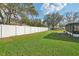 The backyard boasts a new privacy fence and a well-maintained lawn, perfect for outdoor activities at 1408 N Gordon St, Plant City, FL 33563