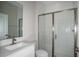 Modern bathroom with a glass-enclosed shower, and a white single-sink vanity at 14441 Meadow Bird Ave, Riverview, FL 33579