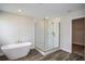 Bathroom featuring freestanding tub, glass enclosed shower, and recessed lights at 14441 Meadow Bird Ave, Riverview, FL 33579