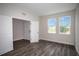 Spacious bedroom with hardwood floors, two windows, and a large closet at 14441 Meadow Bird Ave, Riverview, FL 33579