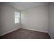 Neutral bedroom with carpet and a large window overlooking a lovely day at 14441 Meadow Bird Ave, Riverview, FL 33579