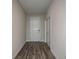 Inviting hallway with wood-look floors leading to a white front door and closet at 14441 Meadow Bird Ave, Riverview, FL 33579