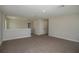 Hallway with neutral carpet, white trim, and white doors at 14441 Meadow Bird Ave, Riverview, FL 33579