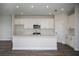 Modern kitchen featuring white cabinets, stainless steel appliances, and a spacious island with a sink at 14441 Meadow Bird Ave, Riverview, FL 33579