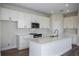 Bright kitchen with white cabinetry, stainless steel microwave, oven, and island sink with ample counter space at 14441 Meadow Bird Ave, Riverview, FL 33579