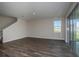 Open-concept living room with wood-look floors and sliding glass doors to patio at 14441 Meadow Bird Ave, Riverview, FL 33579