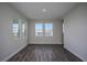 Inviting living room with natural light and wood-look floors at 14441 Meadow Bird Ave, Riverview, FL 33579