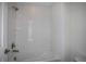 Modern shower featuring white cabinets, a large mirror, and a tub with textured tile at 14441 Meadow Bird Ave, Riverview, FL 33579