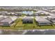 An aerial view showcases the backyard, lake, and neighborhood at 15315 Golden Beam Pl, Bradenton, FL 34211