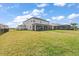 Large backyard with an extended patio and fencing provides a private outdoor area with picturesque lake views at 15315 Golden Beam Pl, Bradenton, FL 34211