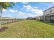 Expansive backyard bordering a tranquil lake is complemented by lush greenery and wrought iron fencing at 15315 Golden Beam Pl, Bradenton, FL 34211