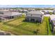 Expansive fenced backyard with lush green grass, view of the property and neighboring homes at 15315 Golden Beam Pl, Bradenton, FL 34211
