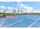 Outdoor basketball court with blue surface and palm tree landscaping is available to the community at 15315 Golden Beam Pl, Bradenton, FL 34211
