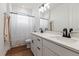 Bright bathroom featuring a double vanity with white countertops, black fixtures, and modern lighting at 15315 Golden Beam Pl, Bradenton, FL 34211