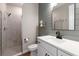 Modern bathroom featuring a walk-in shower, a white vanity, and decorative wood accent wall at 15315 Golden Beam Pl, Bradenton, FL 34211