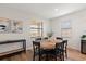 The bright dining room includes wood floors, a wooden table with seating for six, and natural light from two windows at 15315 Golden Beam Pl, Bradenton, FL 34211