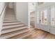 Inviting entryway featuring hardwood floors, staircase, and natural light streaming through the front door at 15315 Golden Beam Pl, Bradenton, FL 34211