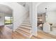 Inviting foyer with staircase, wood floors, natural light, and an open floor plan to the dining room and living spaces at 15315 Golden Beam Pl, Bradenton, FL 34211