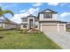 Charming two-story home with a three-car garage and manicured lawn at 15315 Golden Beam Pl, Bradenton, FL 34211