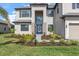 Inviting two-story home features a stone facade and manicured landscaping, creating a welcoming curb appeal at 15315 Golden Beam Pl, Bradenton, FL 34211