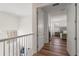 Upstairs hallway with hardwood floors leading to a bedroom, providing a bright and airy feel at 15315 Golden Beam Pl, Bradenton, FL 34211