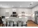 Bright kitchen with white cabinets, stainless steel appliances, and a large center island with bar stools at 15315 Golden Beam Pl, Bradenton, FL 34211