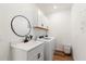 Bright laundry room features white cabinetry, modern washer, sink and stylish fixtures and mirror at 15315 Golden Beam Pl, Bradenton, FL 34211