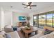 Comfortable living room with wood floors, a ceiling fan, and a sliding glass door to the patio at 15315 Golden Beam Pl, Bradenton, FL 34211