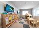 Bright playroom features a playhouse, table, and TV for to enjoy activities and entertainment at 15315 Golden Beam Pl, Bradenton, FL 34211