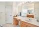 Bright bathroom featuring a large mirror, white countertop with vanity, and ceramic tile floors at 1545 Deerbourne Dr, Wesley Chapel, FL 33543