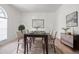 Bright dining room with a dark wood table, neutral chairs, and elegant decor at 1545 Deerbourne Dr, Wesley Chapel, FL 33543