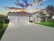 Charming single-story home with three-car garage and a well-manicured lawn for curb appeal at 1545 Deerbourne Dr, Wesley Chapel, FL 33543