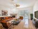 Spacious living room features hardwood floors, a fireplace, and patio access with pool view at 1545 Deerbourne Dr, Wesley Chapel, FL 33543