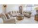 Cozy living room featuring traditional furnishings, a large window, and warm, inviting ambiance at 1545 Deerbourne Dr, Wesley Chapel, FL 33543