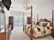Bright main bedroom with a four poster bed, fan and dark wood furnishings at 1545 Deerbourne Dr, Wesley Chapel, FL 33543