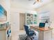 Home office featuring custom shelving, a comfortable workspace, and natural light at 1545 Deerbourne Dr, Wesley Chapel, FL 33543