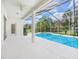 Spacious screened-in lanai with a large swimming pool and lush green landscaping at 1545 Deerbourne Dr, Wesley Chapel, FL 33543