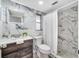 This bathroom has unique tile backsplash, a tile shower with curtain, and a gorgeous vanity at 1811 Forest Dr, Oldsmar, FL 34677